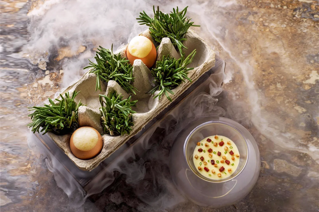 Creative egg‑based dish with rosemary and creamy sauce served with dry ice presentation — signature molecular gastronomy plate at Odette Singapore.