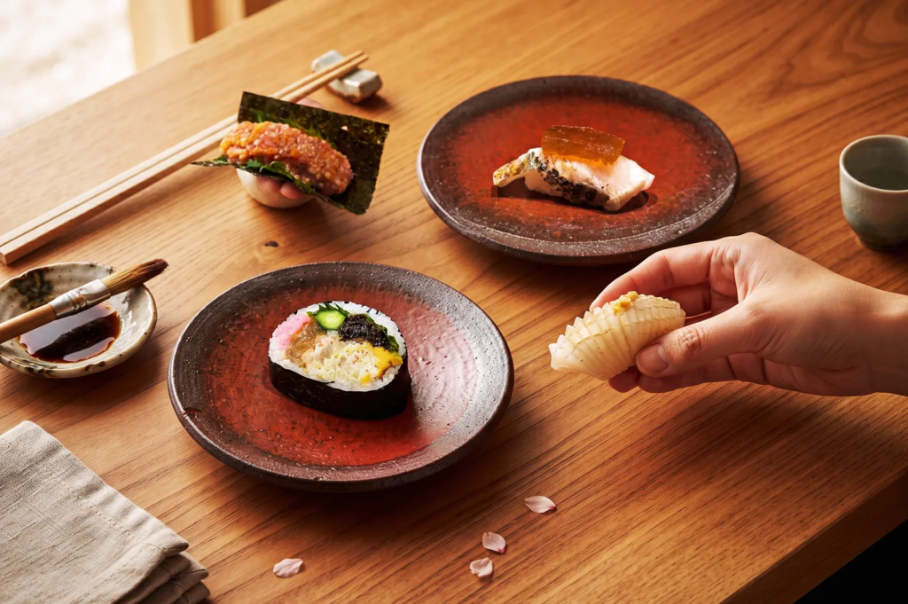 Artfully plated sushi assortment on handcrafted ceramic dishes, showcasing premium Japanese ingredients and meticulous presentation in a traditional omakase setting.