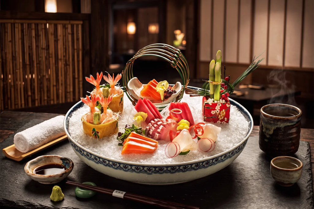 Exquisite sashimi platter with tuna, salmon, shrimp, and radish garnishes on crushed ice — premium Japanese seafood presentation in traditional setting.